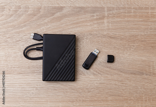 Fényképezés External hard drive with USB stick on wooden table