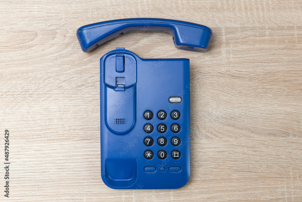 Office landline phone on wooden table Office landline phone on wooden table