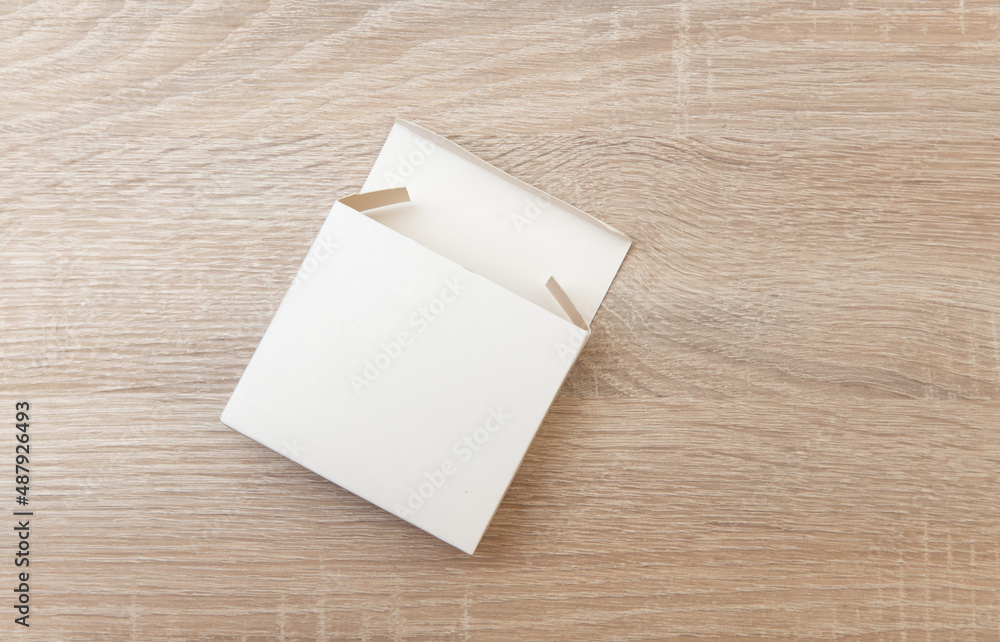 Empty white box on wooden table. Top view Empty white box on wooden table. Top view