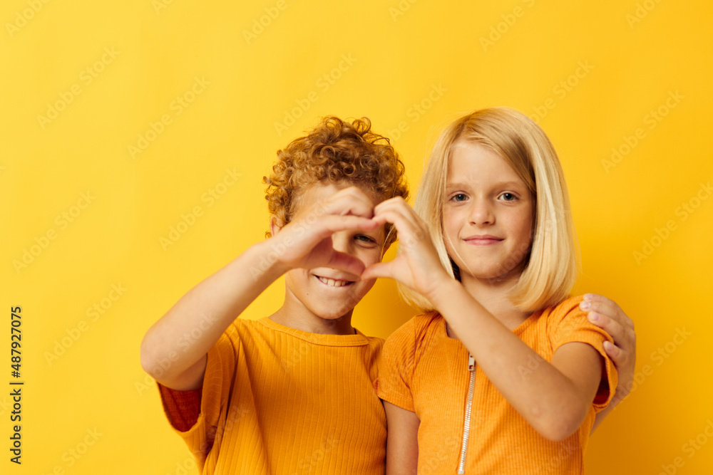 picture of positive boy and girl cuddling fashion childhood entertainment on colored background picture of positive boy and girl cuddling fashion childhood entertainment on colored background