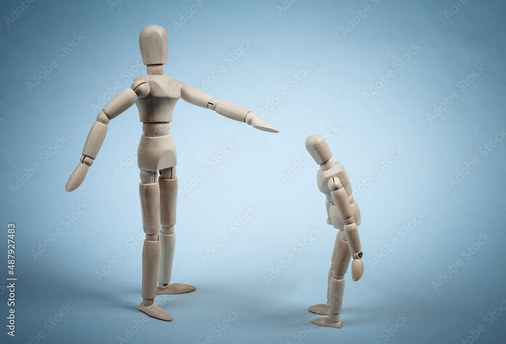 Angry parent puppet points with hand and scolds the child. Negative emotion, teenage problem concept. Isolated on blue Angry parent puppet points with hand and scolds the child. Negative emotion, teenage problem concept. Isolated on blue