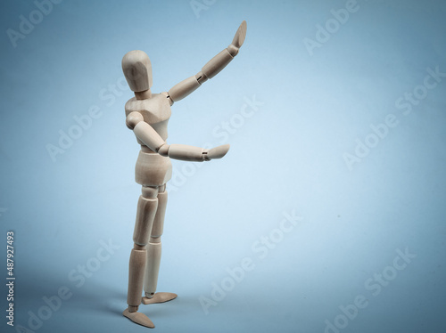 Wooden puppet isolated on blue background