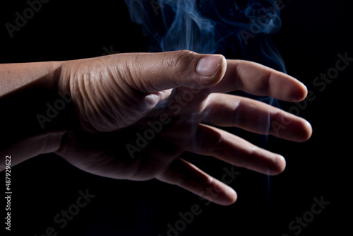 male hand with magic white smoke.