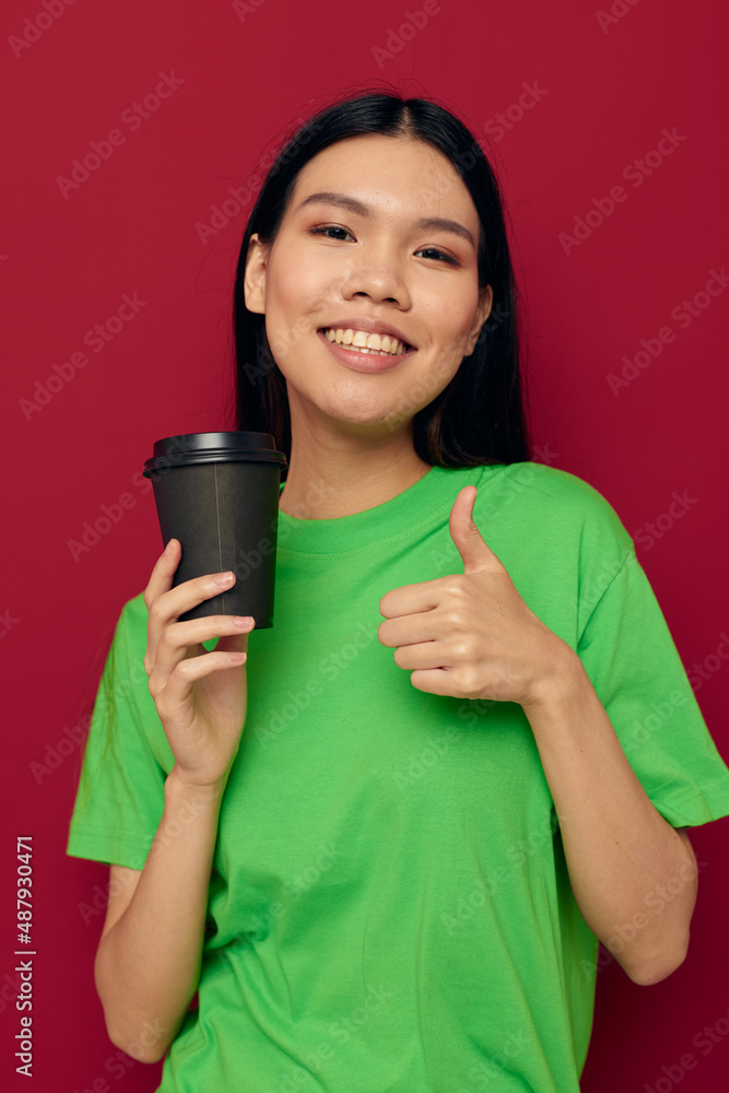 Charming young Asian woman posing in a green t-shirt disposable black glasses studio model unaltered