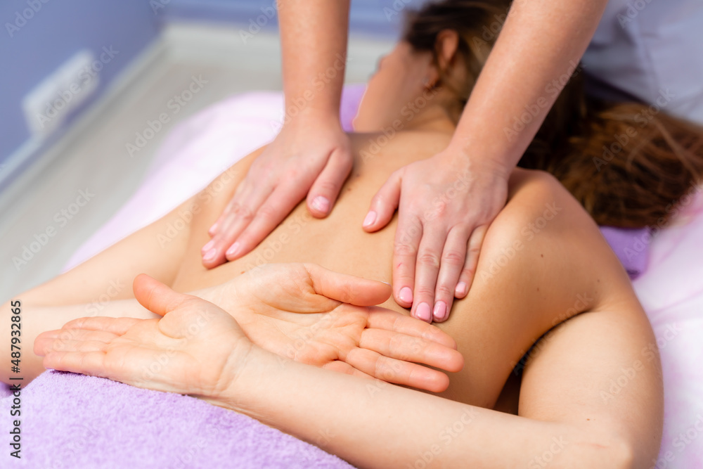 Top view of hands massaging female abdomen.Therapist applying pressure on belly. Woman receiving massage at spa salon Top view of hands massaging female abdomen.Therapist applying pressure on belly. Woman receiving massage at spa salon
