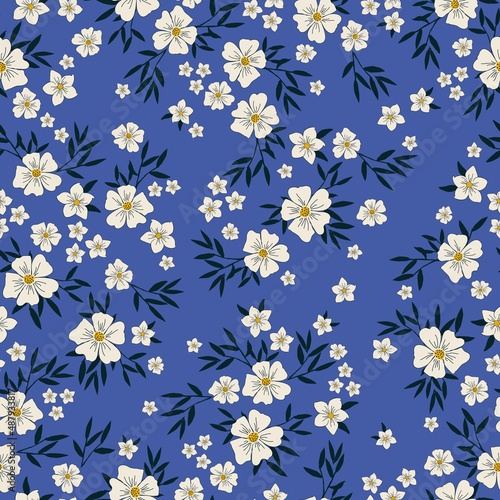 Seamless vintage pattern. White flowers . dark blue leaves. Blue background. vector texture. fashionable print for textiles, wallpaper and packaging.