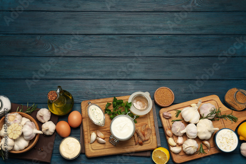 Concept of cooking garlic sauce on wooden background