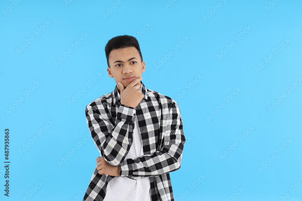 Young man in checkered shirt on blue background Young man in checkered shirt on blue background