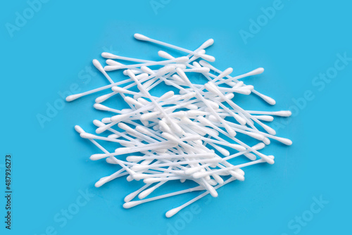 Cotton buds on blue background.