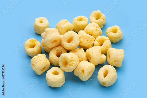 Roller corn snack on blue background.
