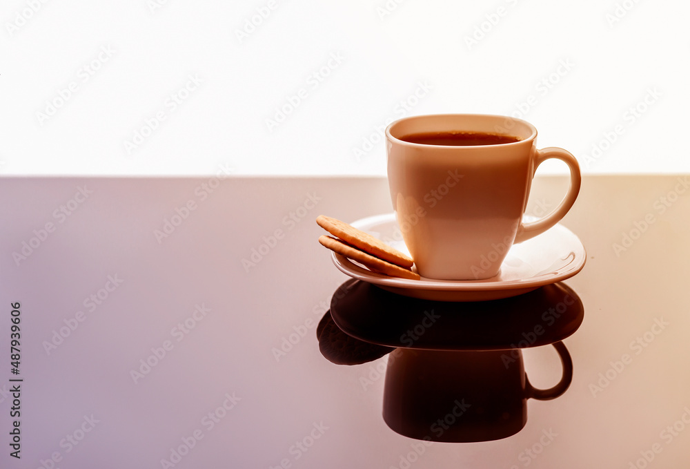 Coffee cup on table. White tea mug with a saucer on a glossy table Coffee cup on table. White tea mug with a saucer on a glossy table