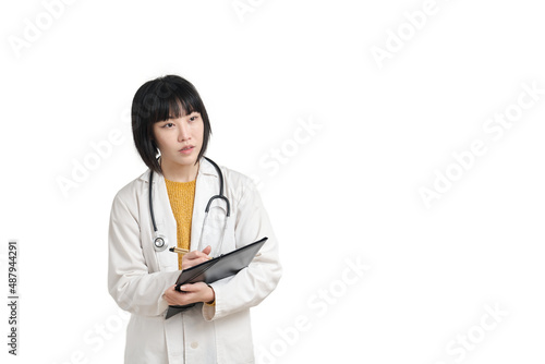 Young asian female doctor listening and writing on a paper, isolated on white background.