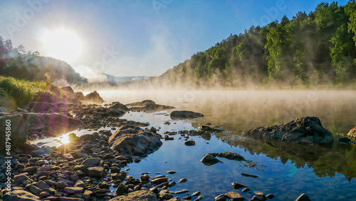 evaporation of water in the river early in the morning at dawn