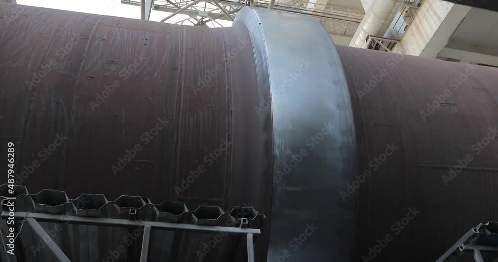 Big tube working in the big factory. Pipe is turning. Pipe transporting raw materials. Tube transporting liquid. Big tube working in the big factory. Pipe is turning. Pipe transporting raw materials. Tube transporting liquid.