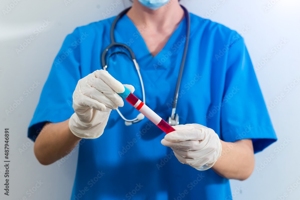 Scientist holding test tube with blood sample, focus on hand. Scientist holding test tube with blood sample, focus on hand.