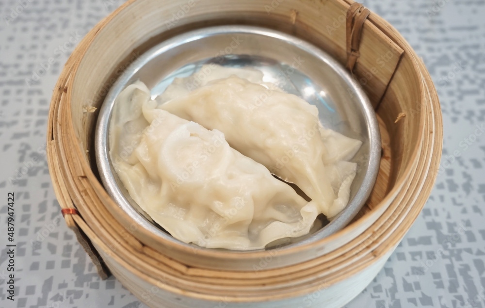 Streamed dumplings in bamboo container Streamed dumplings in bamboo container