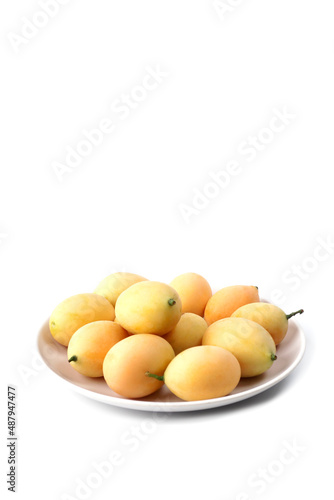 Plango fruit or Marian plum in white dish isolated on white background