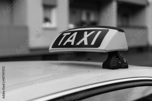 Taxi sign on a German taxi from the right in black and white