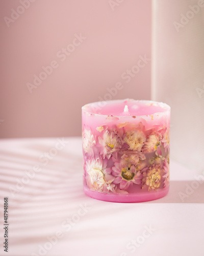 Handmade candles with dried flowers unique design. Scented candles decorated by dry leafs and blooms.