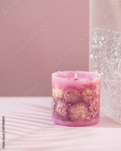 Handmade candles with dried flowers unique design. Scented candles decorated by dry leafs and blooms.