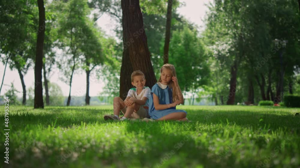 Joyful kids playing under tree. Smiling children have fun outdoors on weekend. Joyful kids playing under tree. Smiling children have fun outdoors on weekend.