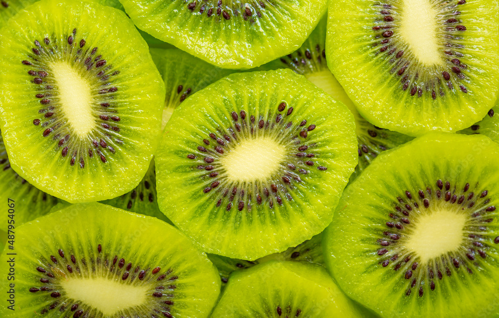 Kiwi closeup as background. Ripe kiwi fruit in the cut. Kiwi seed texture. Kiwi closeup as background. Ripe kiwi fruit in the cut. Kiwi seed texture.