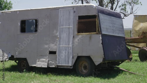 Close up pan right shot of abandoned vehicles on roadside near Saladas, Argentina photo