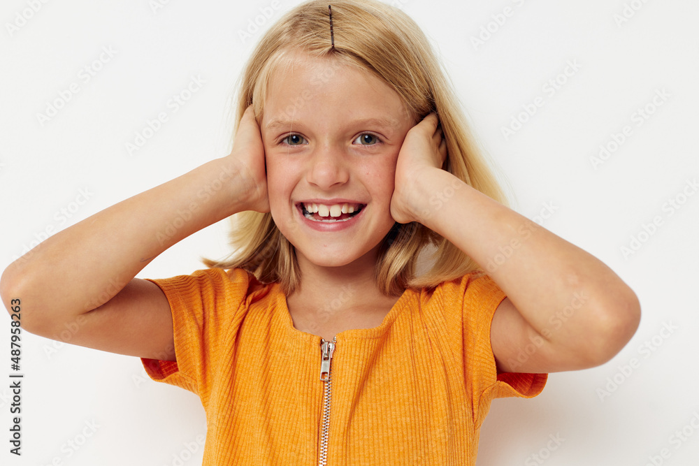 cheerful girl in a yellow t-shirt posing emotions light background cheerful girl in a yellow t-shirt posing emotions light background
