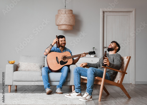 Male friends with bottles o...