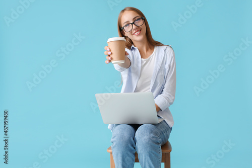 Pretty young woman with cup...