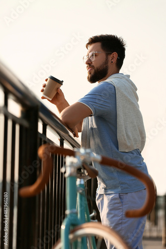 Young bearded man with cup ...
