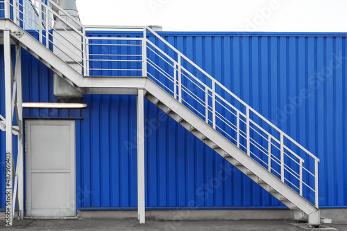 Modern metal stairs of blue building outdoors