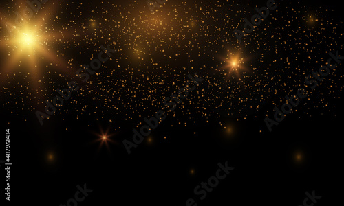 Golden flash in the sky, bright star, shiny dust on a black background © Hanna