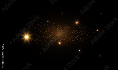 Golden flash in the sky, bright star, shiny dust on a black background