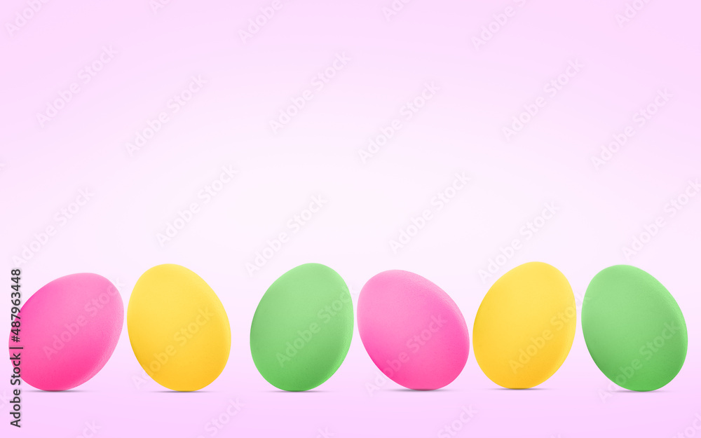 Colorful Easter eggs on a pink background.