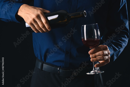 Young male sommelier with w...