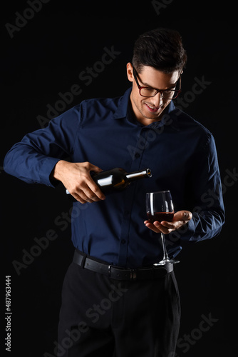 Young male sommelier with w...