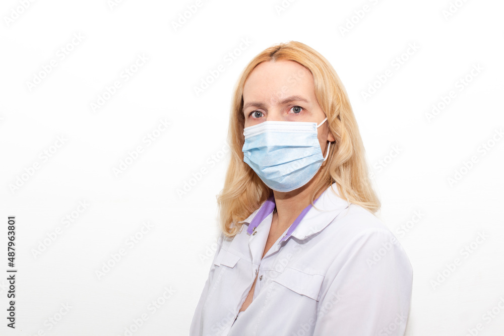 Cheerful young female doctor in mask and gloves looking at camera isolated on white Cheerful young female doctor in mask and gloves looking at camera isolated on white