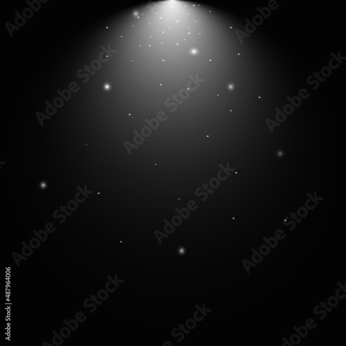 Spotlight, falling dust from sparkles and flares on a black background