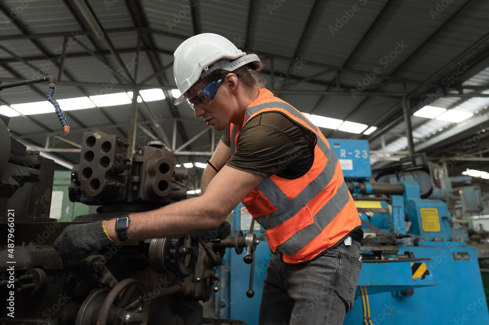 Engineer, foreman hard work with machine at factory Engineer, foreman hard work with machine at factory