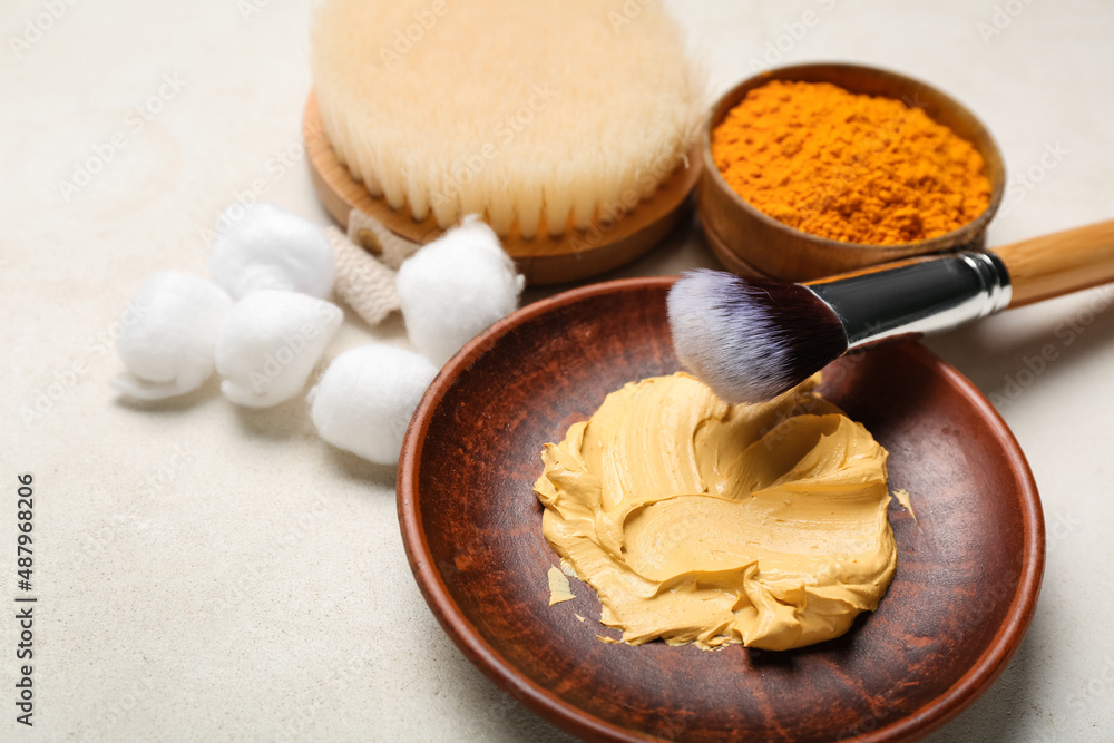 Plate with turmeric mask, powder and cotton balls on light background, closeup Plate with turmeric mask, powder and cotton balls on light background, closeup