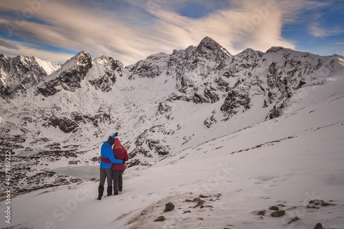 Obraz na płótnie Beautiful winter mountain landscape. Couple in love on a trail in the Polish Tatra Mountains. w salonie