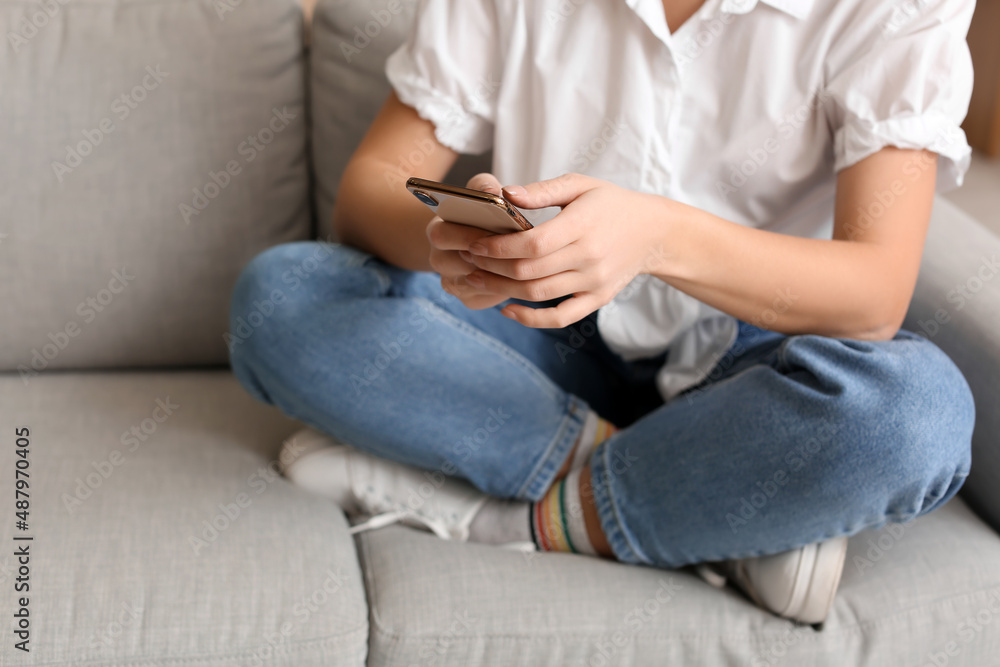 Pretty young woman using mobile phone at home Pretty young woman using mobile phone at home