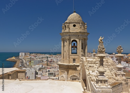 Bell tower of the Santa Cruz cathedral of Cadiz, with the city and sea in the background