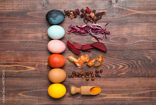 Beautiful Easter eggs and natural dyes on wooden background