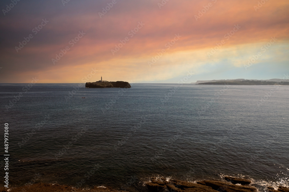 Fototapeta premium sunset over the sea with lighthouse
