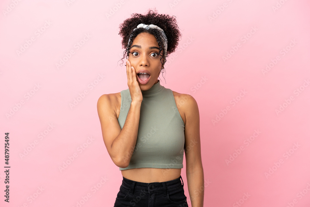 Young latin woman isolated on pink background with surprise and shocked facial expression Young latin woman isolated on pink background with surprise and shocked facial expression