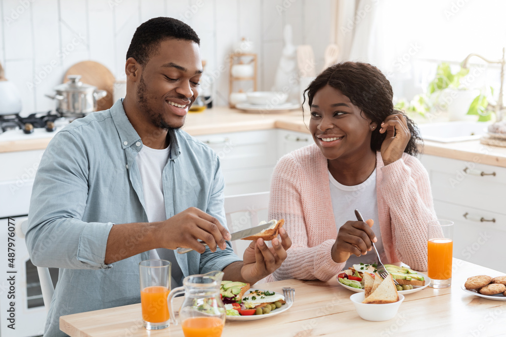 Breakfast At Home. Young Black Couple In Kitchen Eating Morning Meal