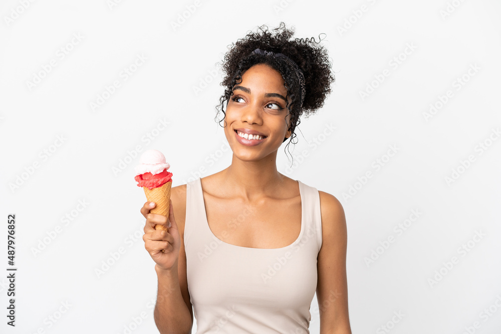 Young african american woman with a cornet ice cream isolated on white background thinking an idea while looking up Young african american woman with a cornet ice cream isolated on white background thinking an idea while looking up