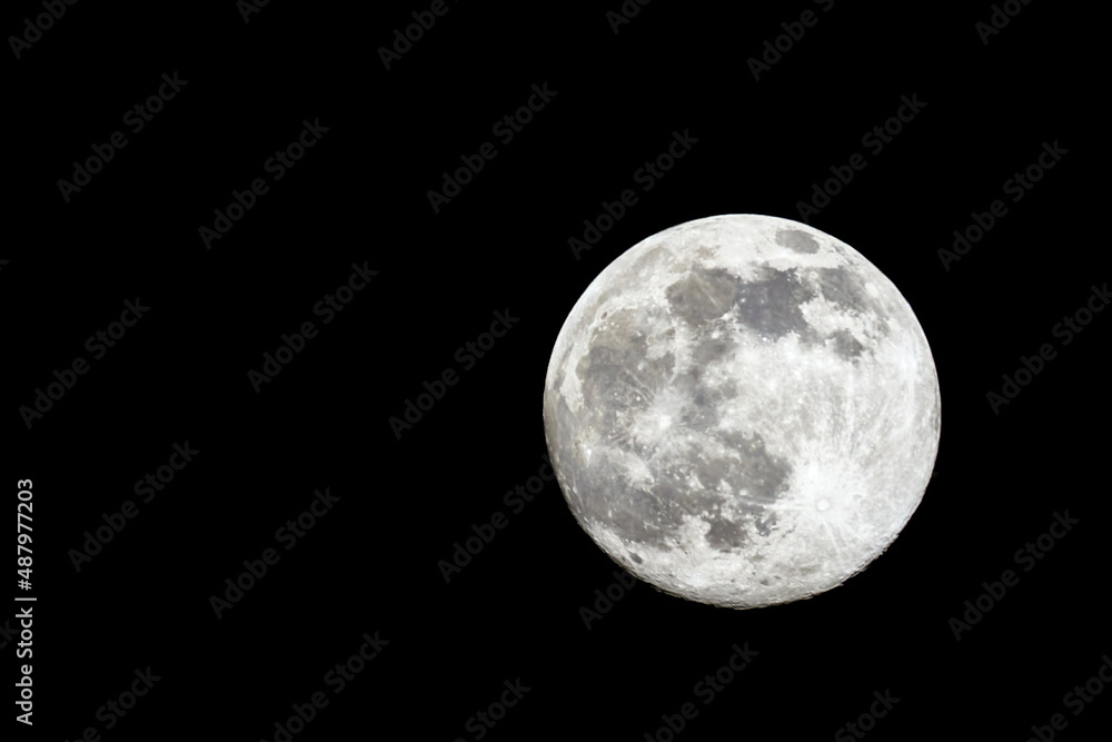Full moon close-up on the right side of the picture on a black background Full moon close-up on the right side of the picture on a black background
